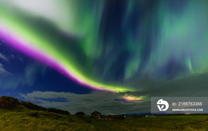 Northern lights, Aurora Borealis in the night sky, Iceland. These colourful curtains of dancing lights can illuminate the night sky