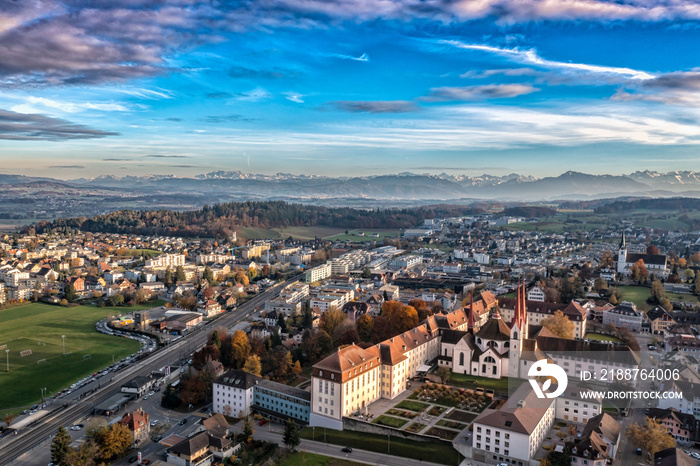 aerial view of an monastery with view of the alps