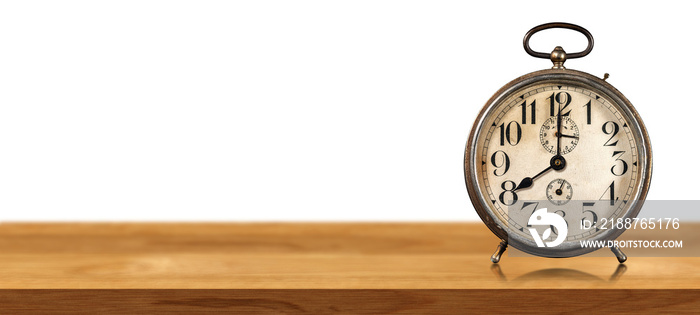 Closeup of an old alarm clock on a wooden table isolated on white or transparent background with copy space. Eight o’clock, Italy. Png.