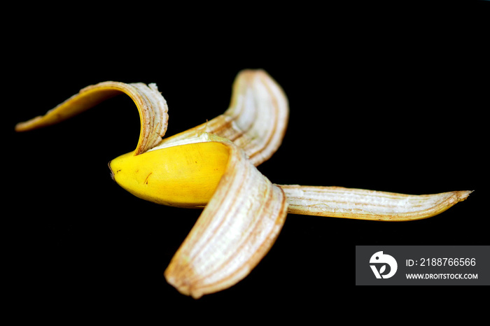 banana peel, peeled half a banana on a black background,