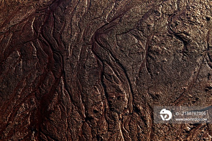 abstract mud background with water washout trails and selective focus