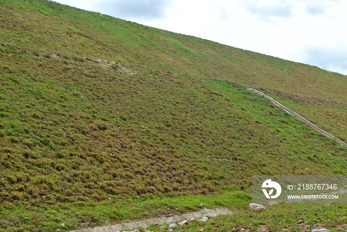 Permanent slope protection with grass using the hydroseed method. The grass is used to stabilizes the slope structure and prevent slope erosion. Effective and less maintenance.