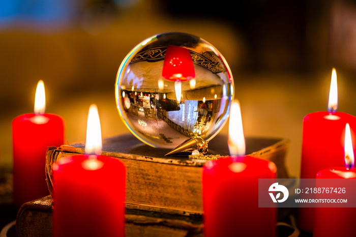 Crystal ball to prophesy or esoteric clairvoyance during a Seance in the candle light