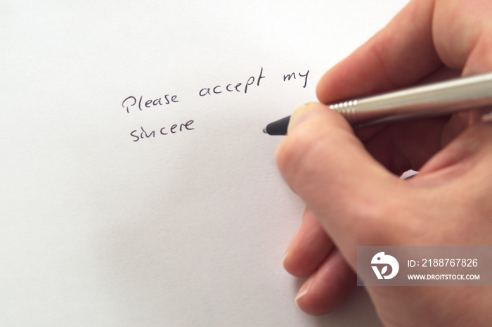 Please accept my sincere ... (apologies) in handwriting by hand with pen on white paper