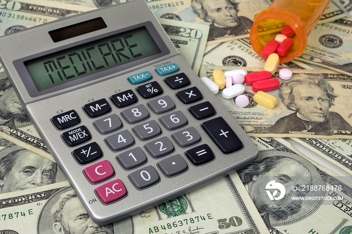 medicare text sign on calculator screen with prescription drugs and pill bottle on American money