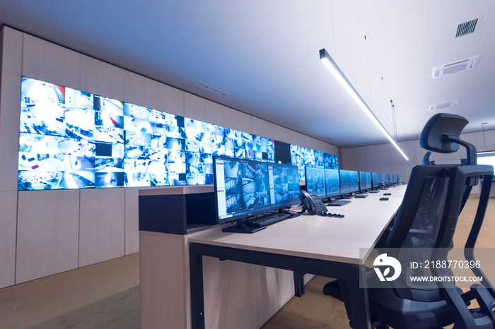 Security guard monitoring modern CCTV cameras in surveillance room