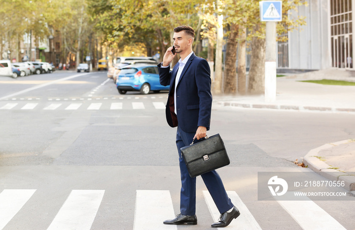 Handsome businessman on pedestrian crosswalk