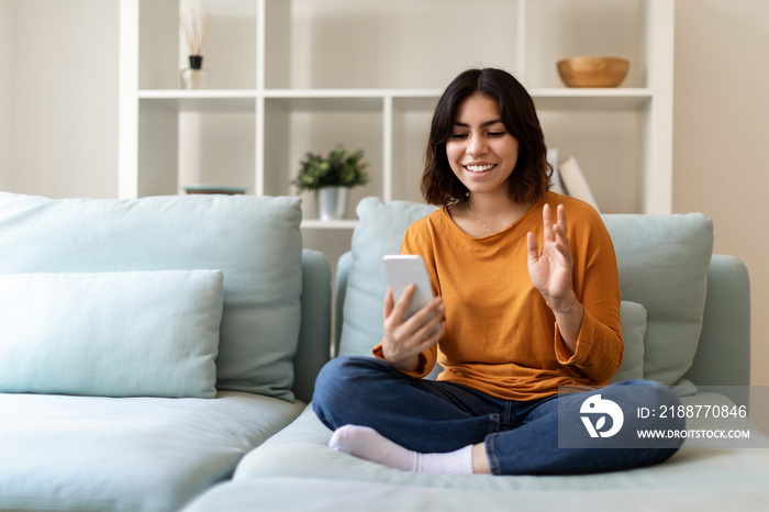 Online Communication. Happy Arab Woman Making Video Call Via Smartphone At Home