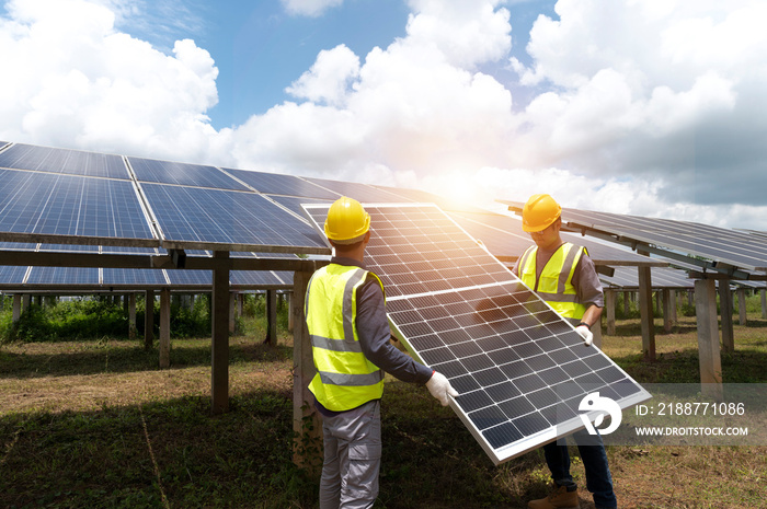 A team of male engineers is about to install solar panels. at the solar power station Engineer team ordered and installed solar cells.