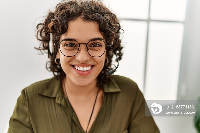 Young hispanic woman smiling confident wearing headset working at office