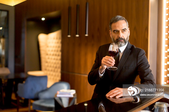 Senior handsome man drinking red wine