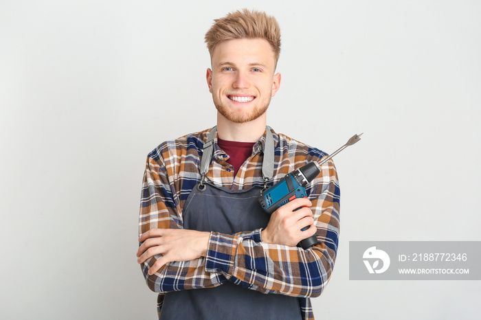 Male carpenter on grey background