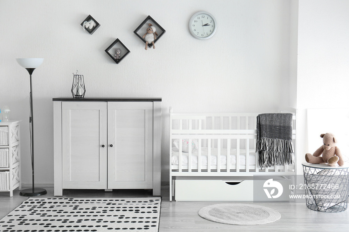 Interior of stylish children’s room with baby bed