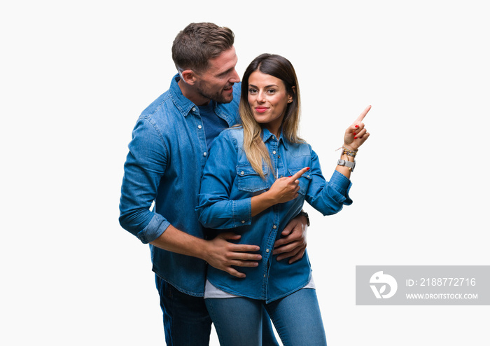 Young couple in love over isolated background smiling and looking at the camera pointing with two hands and fingers to the side.