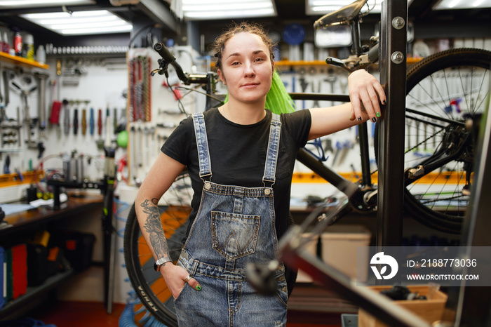 Confident mechanic in bike repair workshop