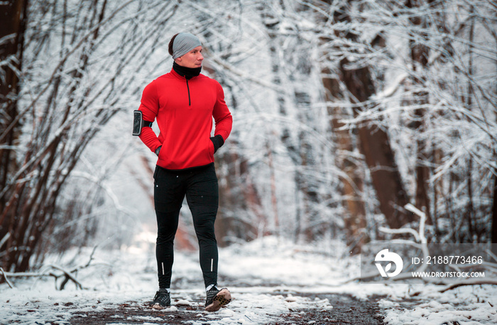 Winter running training, runner at cold snow weather