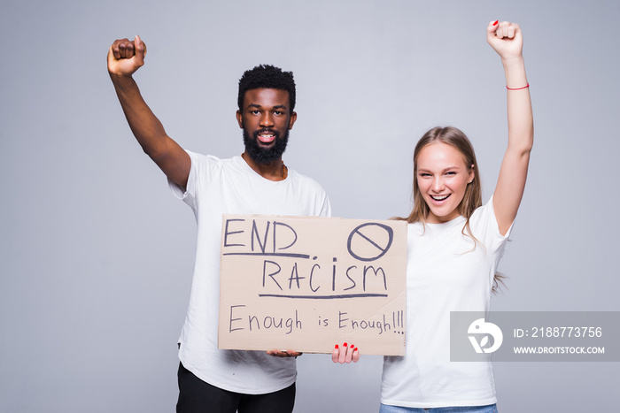 Young african man and coucasian woman holding a cardboard poster with the message text END RACISM isolated on white background, Concept on the theme of protest for police brutality and racism.