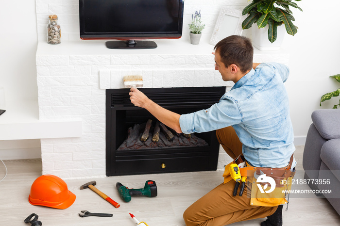 Fireplace installing in white brick wall