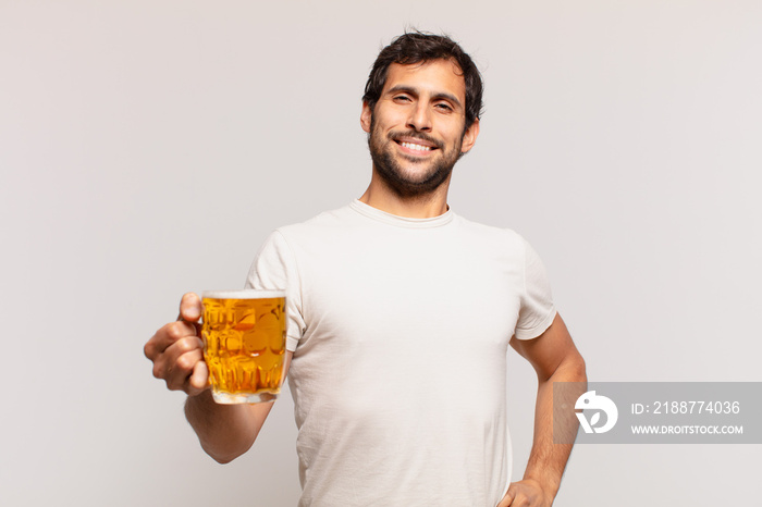 young handsome indian man happy expression and holding a beer