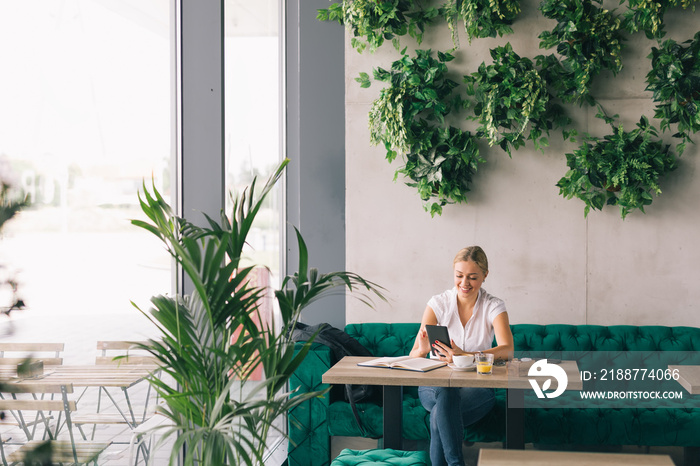 Woman using her tablet in cafe bar