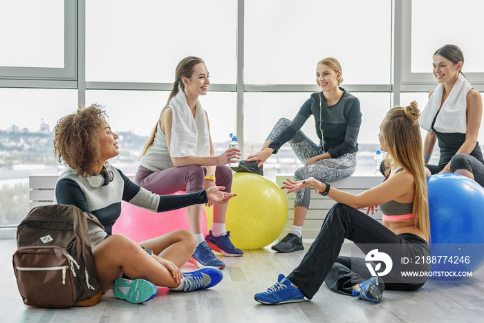 Happy smiling young women in gym