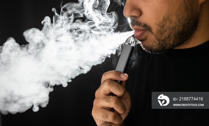 Close-up mouth of man smoke inhaling, breathing and smoke electronic cigarette.