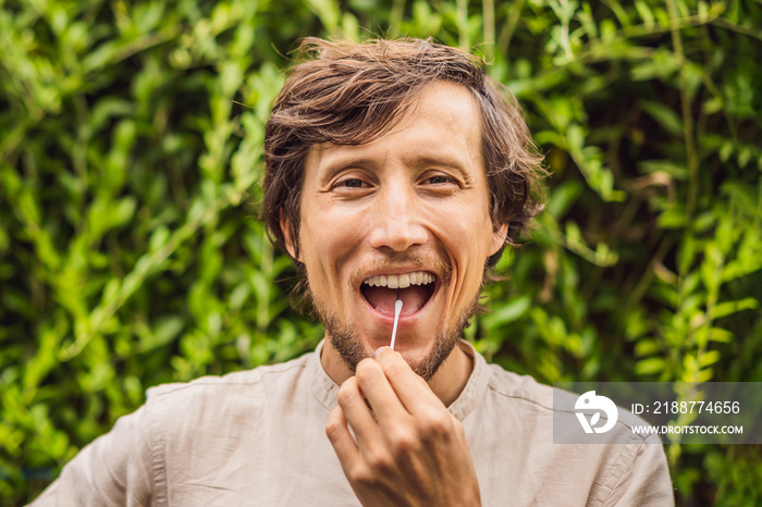 Man doing DNA test with cotton swab. Test for home use