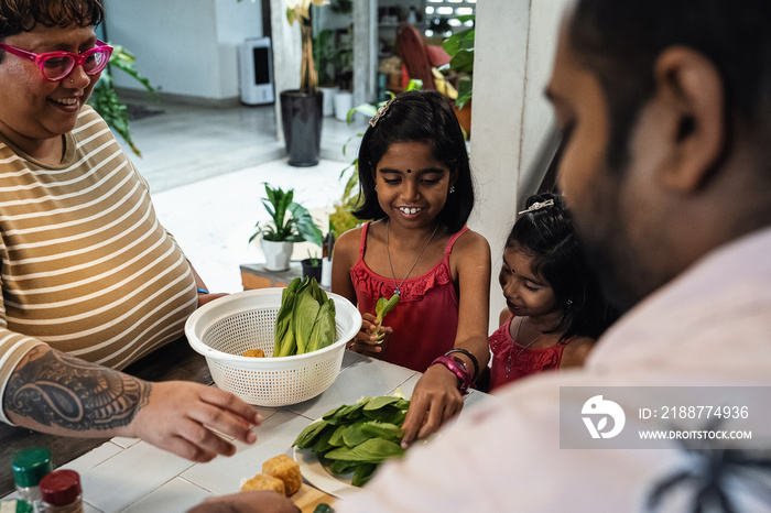 Kids helping their parent cook a healthy meal for the family dinner at home