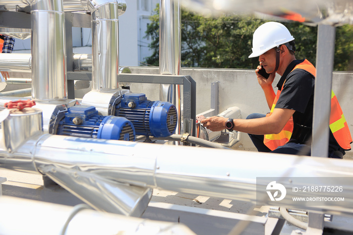 Engineers or electricians are working on equipment inspection and maintenance. Checking the operating status of cooling systems and .talking telephone.