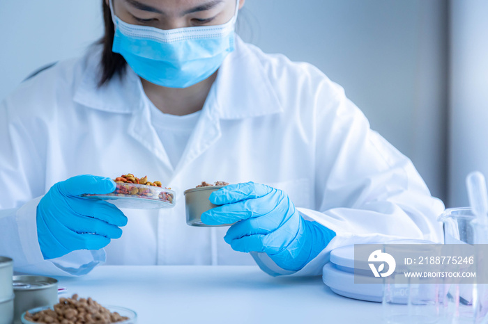 Quality control personnel are inspecting the quality of dry pet food. Physical quality inspection. Quality control process of pet food industry.