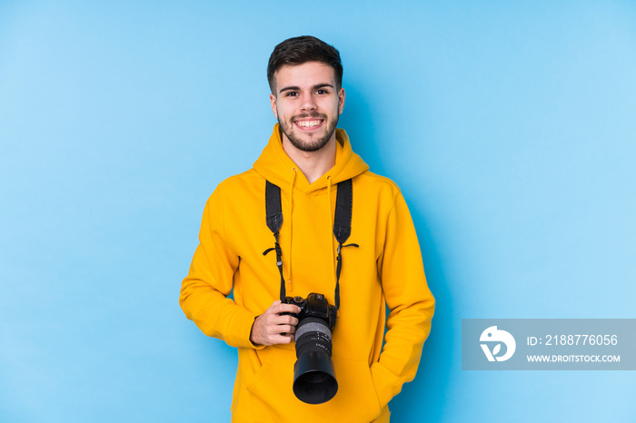 Young caucasian photographer man isolated happy, smiling and cheerful.