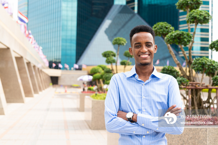 Portrait of handsome young black man outdoors in city