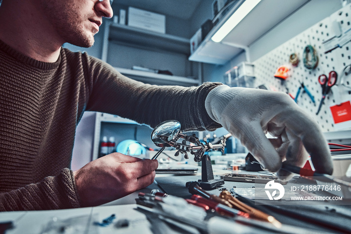 Electronic technician working in the modern repair shop