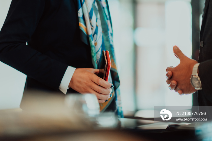 Photo of a businessman and businesswoman discussing business projects in a modern corporation. Selective focus