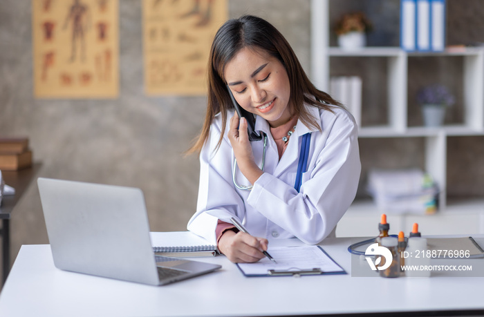 Young Asia Female  doctor talking on a cellphone in a modern office