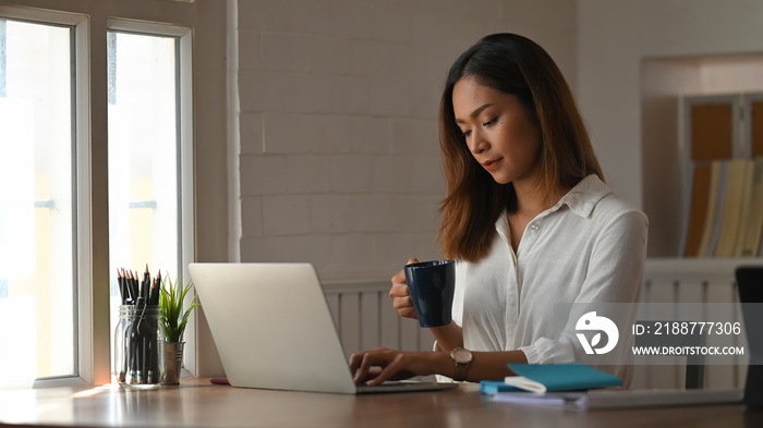 Businesswoman working her home office with laptop computer.