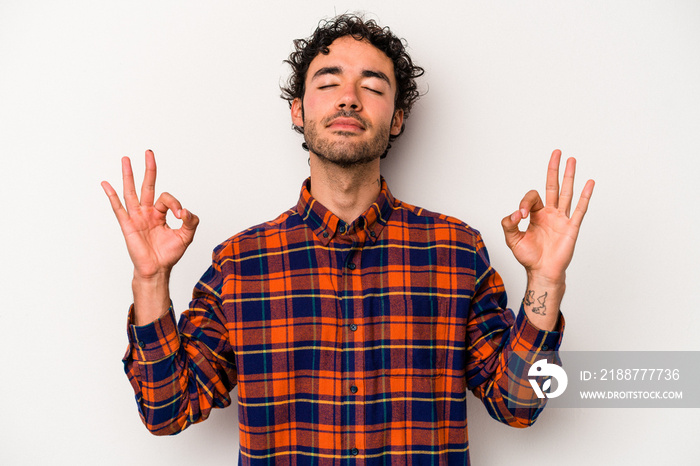 Young caucasian man isolated on white background relaxes after hard working day, she is performing yoga.