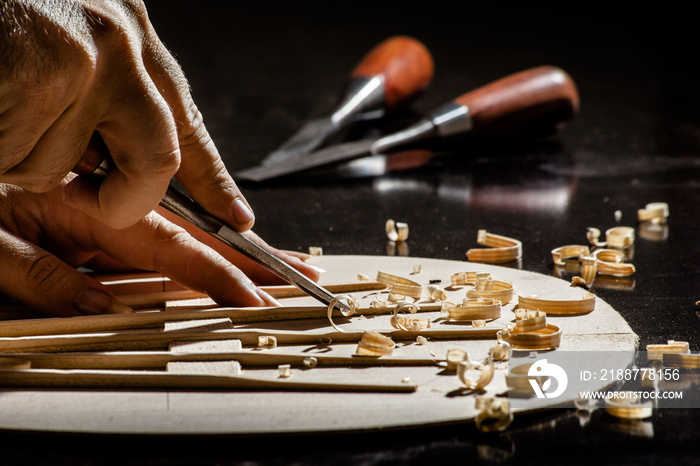 Luthier making top of guitar