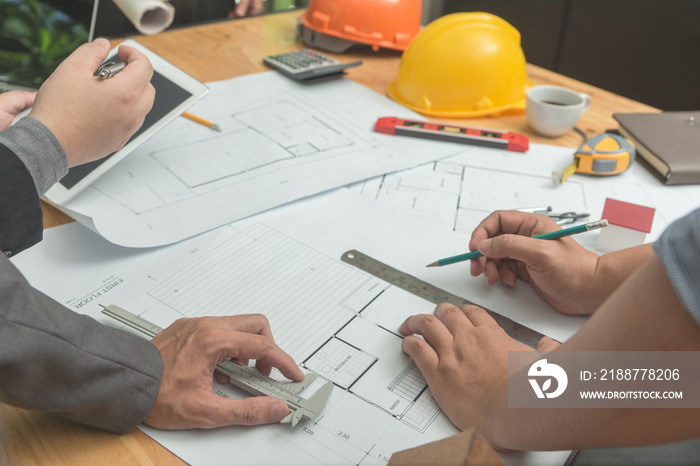 Architects engineer discussing on desk with blueprint. Team group on construciton site check documents and business workflow.Construction concept. Engineering tools.Vintage effect.Selective focus.