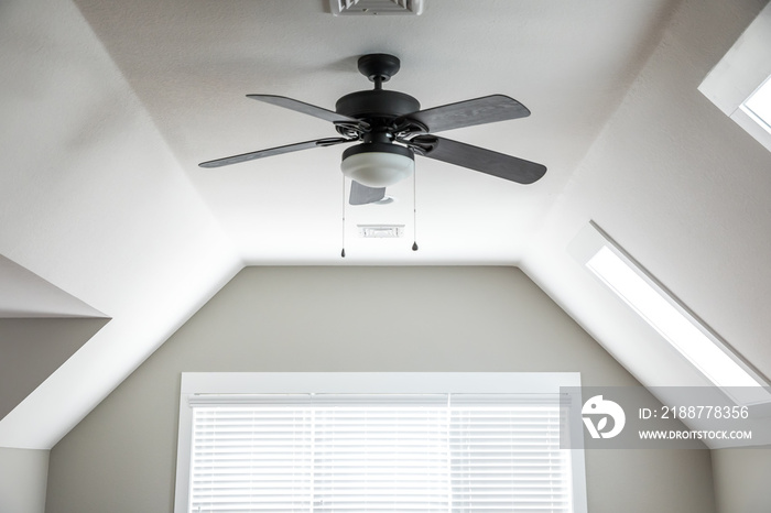 Open and airy bonus room game room in a new construction house with a dark wood ceiling fan, a window and blinds