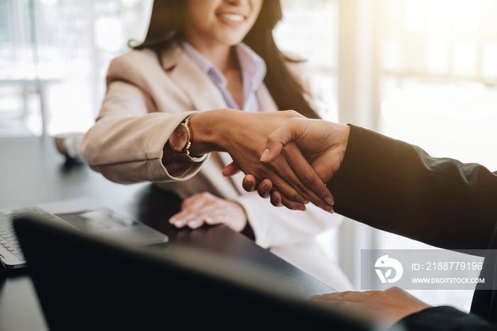 Close up of asian business people shaking hand, finishing up meeting, business etiquette, congratulation, merger and acquisition concept.