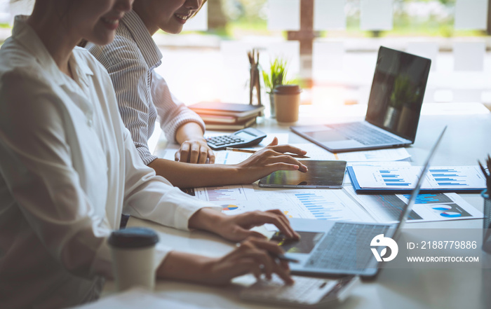 Businessmen holding pens and graph paper are meeting to plan sales to analyze investment results and profits for the growth of the company.