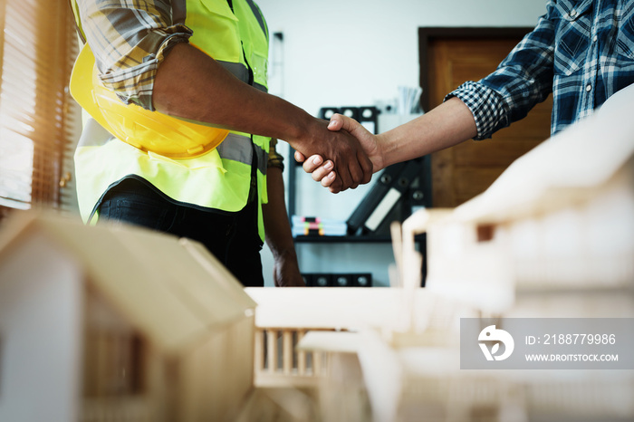 Engineers shaking hands to congratulate after success To create a building architecture successfully according to the goals that have been set