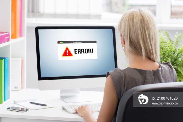 Woman looking at unknown error notification on computer’s screen