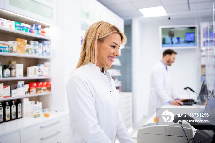 Female caucasian pharmacist selling medicines in drug store.