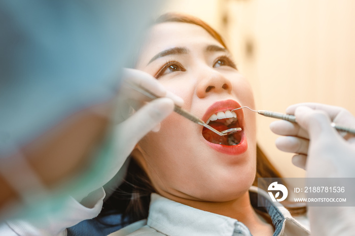 Dentist examining teeth patients in clinic for better dental health and a bright smile.Dentist is scraping limestone.Dentist tools and equipment.