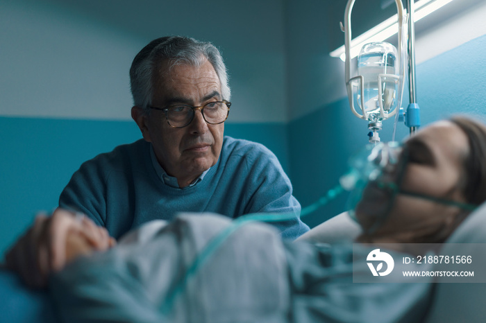 Senior man assisting her daughter at the hospital