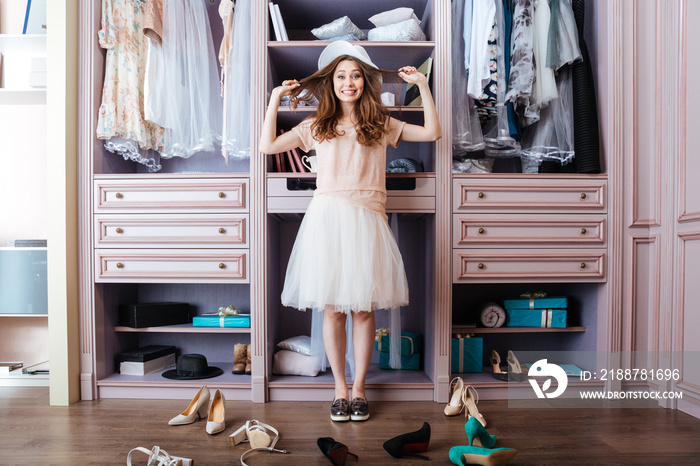 Girl choosing shoes in her wardrobe