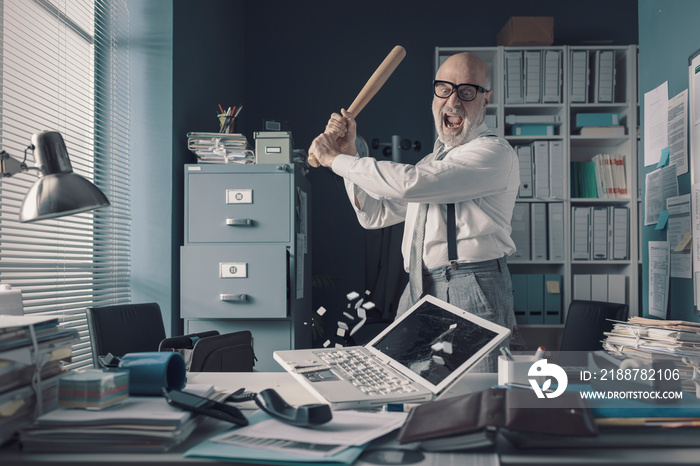 Crazy businessman destryoing his office with a baseball bat