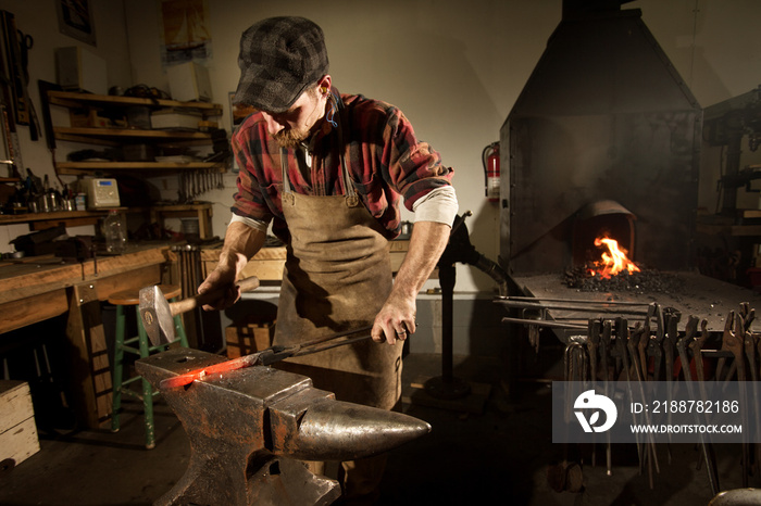 Blacksmith working on metal at workshop